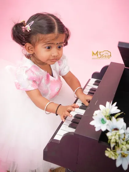 A focused moment as she explores the piano keys. These sessions are all about letting your baby interact with the world around them.