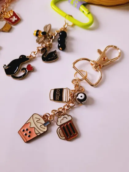 Another angle of the custom keychains, showing the foodie and animal-themed charms side-by-side.