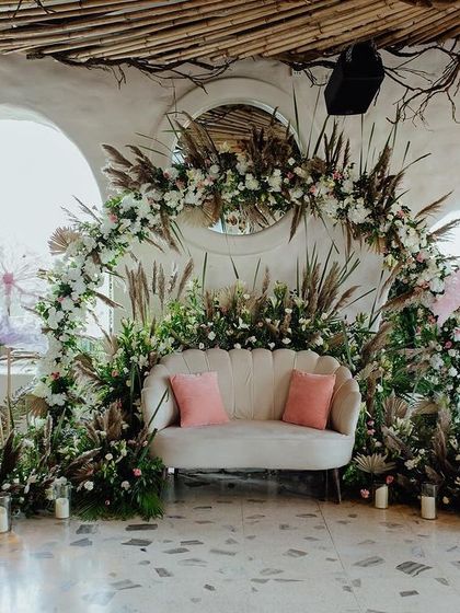 The full view of the bohemian-inspired stage, where natural textures like pampas grass and dried palms are combined with soft florals and candlelight for a romantic, earthy vibe.