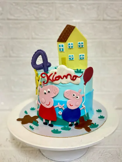 Oink oink. A fun Peppa Pig and George cake for a 4th birthday celebration. This chocolaty caramel cake is decorated with their house and muddy puddles, of course.