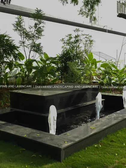 A side view of the modern water fountain, showing the water spouts and the depth of the basin.