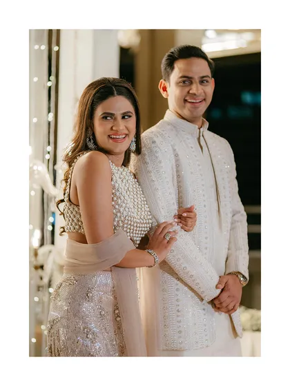 A happy, candid moment between Amy and Joe. Their bright smiles and coordinated outfits shine in this light-filled portrait from their elegant wedding celebration.