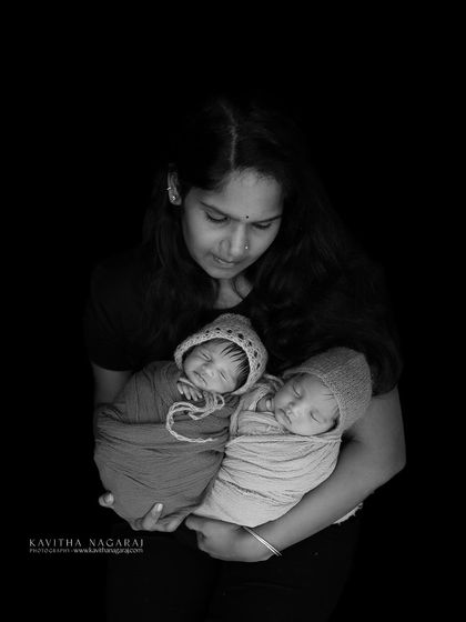A mother's arms full of love, holding her precious newborn twins. This timeless black and white portrait is a beautiful testament to the strength and joy of a twin mom.