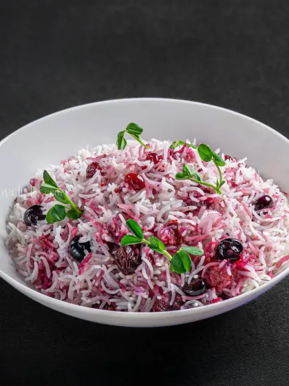 A beautiful berry pulao, with vibrant colors from berries and fresh herbs mixed with white rice.