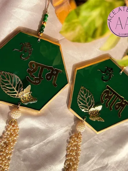 An elegant hexagonal design for my green Shubh Labh hangings. The clean lines combined with traditional Hindi script and pearl tassels create a balanced and beautiful decor item.