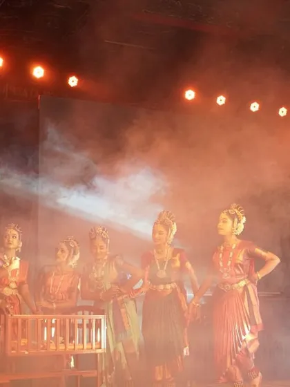 A scene from "KRISHNA" filled with smoke and dramatic lighting, creating a sense of celebration and divine intervention as the gopis surround the cradle.