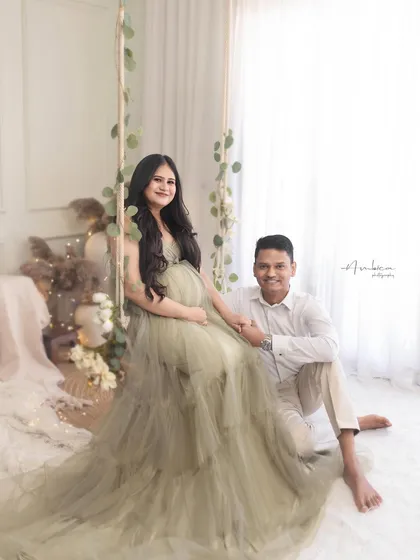 A playful and sweet moment with the couple seated on the floor by the swing. It shows the fun and relaxed atmosphere I strive to create during my sessions.