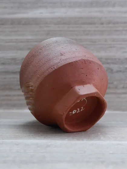 The base of the teabowl, showing the faceted foot and my signature from 2022. The details on the bottom of a pot are just as important as the rest.