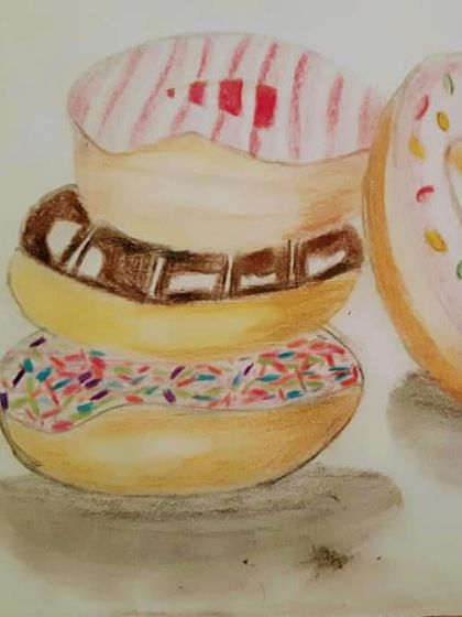 A student's drawing of a stack of donuts with colorful sprinkles and icing.
