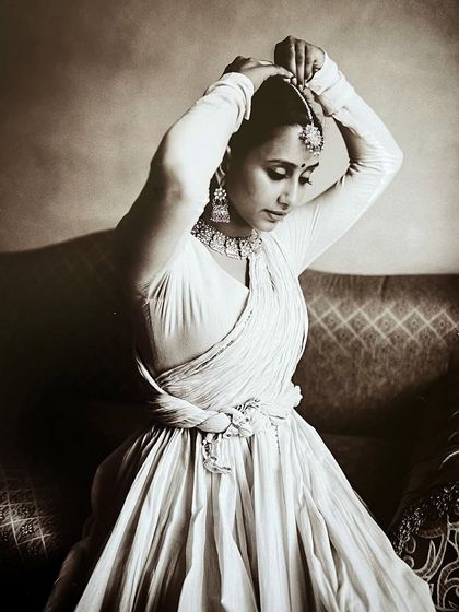 Getting ready for a historical-themed photoshoot, adjusting my headpiece. This image captures the preparation and detail that goes into each artistic project.