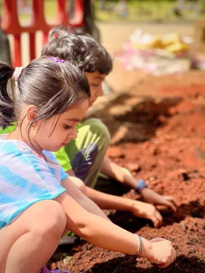 Here, two young explorers are getting to know the earth up close. Creating opportunities for children to interact with soil and plants fosters curiosity and a lifelong appreciation for nature. All my community gardening projects are designed to be safe and educational.