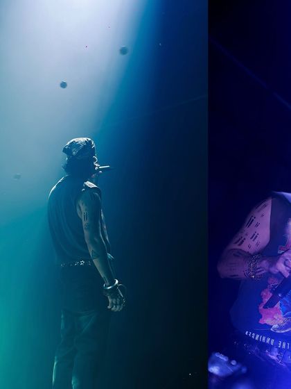 A moody shot of Talwiinder under a blue spotlight, looking out into the darkness. This captures the mysterious and atmospheric side of his stage persona.