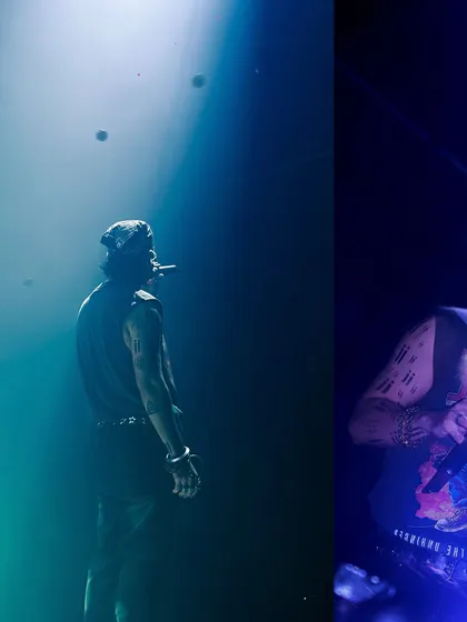 A moody shot of Talwiinder under a blue spotlight, looking out into the darkness. This captures the mysterious and atmospheric side of his stage persona.
