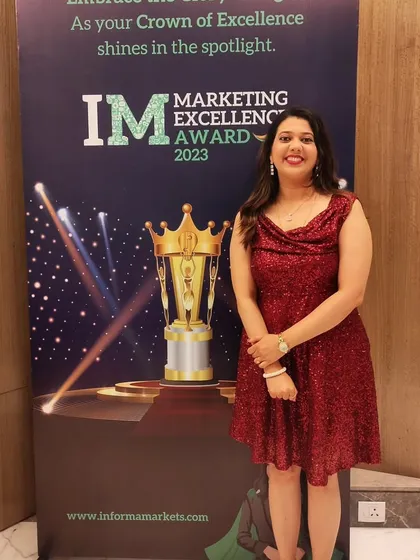 Posing by the official event banner for the Marketing Excellence Awards 2023. It was an honor to be the chosen anchor for an evening celebrating the best in the marketing industry.