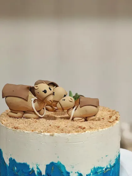 A close-up of the sweet fondant camel family. It's these little personal touches that make a custom cake so special.