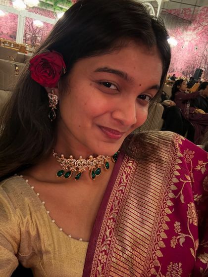 A close-up selfie showing my festive look with a rose in my hair. It's all in the details.