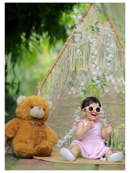 A relaxed, bohemian-style outdoor shoot featuring a macrame teepee and a friendly teddy bear. This setup is perfect for soft, natural, and whimsical portraits.