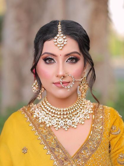 A look that shines with grace and magic. I created a soft glam look with dramatic eyes to complement her yellow and green velvet lehenga, perfect for an Anand Karaj ceremony.