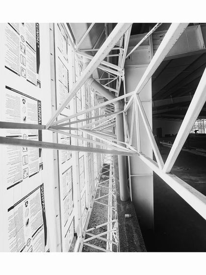 A site diary photo showing the intricate steel truss work of a project under construction. We often leave structural elements exposed to celebrate the craft and engineering of our buildings.