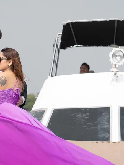 A stylish pose on the back of a yacht, with the bride's flowing dress adding a touch of glamour to this Goa pre-wedding shoot.
