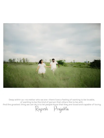 A beautiful wide shot of the couple running through a field, capturing a feeling of freedom and happiness.