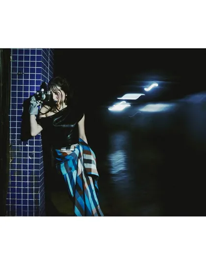 An image using motion blur from passing car lights to add a dynamic element to a dark, atmospheric scene. This technique enhances the feeling of a fleeting, candid moment.