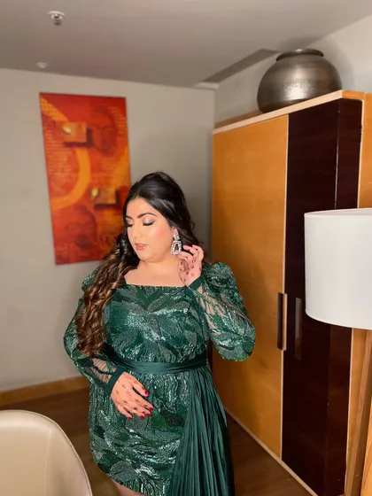 A glam goddess in this green ensemble. This look is perfect for a cocktail party or reception, featuring a dramatic eye, contoured features, and beautiful wavy hair.
