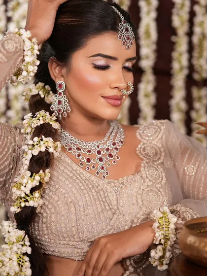 This shot showcases the complete bridal look, including the detailed hair, makeup, and how the accessories tie everything together.