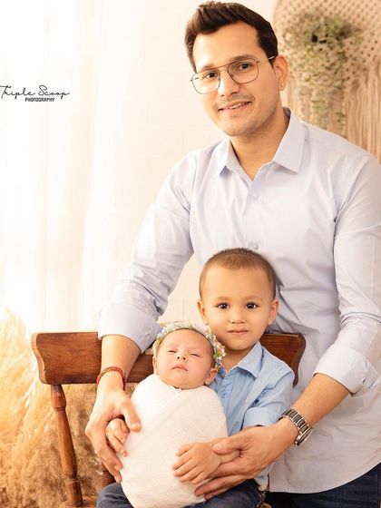 A proud father with his two children. Capturing the relationship between siblings, even at this early stage, is so important.