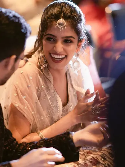 The laughter and joy of a sangeet night. This candid shot shows how her makeup looks just as fresh and flawless mid-celebration as it did at the start. slight blush and a berry-toned lip.