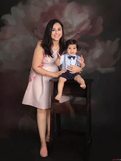 A classic mother and son portrait. The little boy looks so dapper in his bow tie, and his mom's smile is full of pride and love.