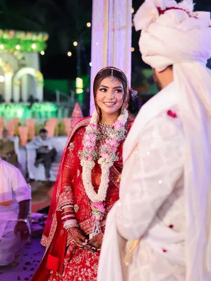 That look of love. A candid moment between the bride and groom during their wedding ceremony, with her makeup looking flawless and radiant.