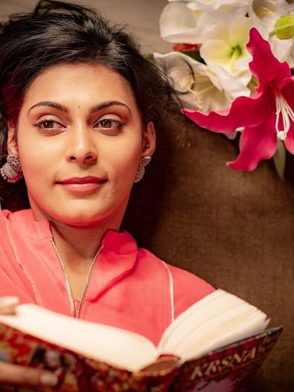 A thoughtful and serene portrait. The warm lighting and relaxed pose create a peaceful mood.