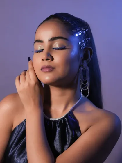 A serene, eyes-closed pose that showcases the sharp, electric blue winged liner. Precision is a skill I drill into all my students.