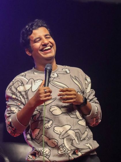 A shot of Aditya Kullu laughing along with his audience, showcasing the fun and relaxed atmosphere of his shows.