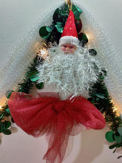 A handmade Santa Claus ornament, perfect for adding a touch of magic to your Christmas decorations. We love adding these small, unique details to our festive setups.