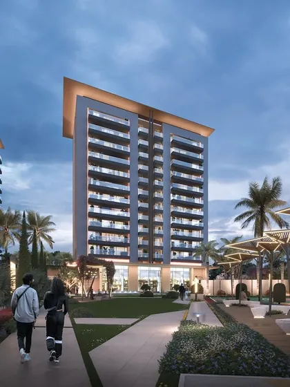 Another evening view of Gulnaar Zenium, emphasizing the warm interior lighting visible through the expansive balconies, creating a sense of a vibrant community.