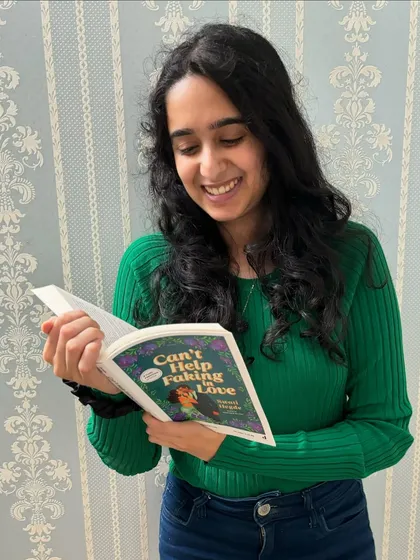 Reading an advance copy of *Can't Help Faking in Love*. It's always a special moment to see the words I wrote in a physical book.