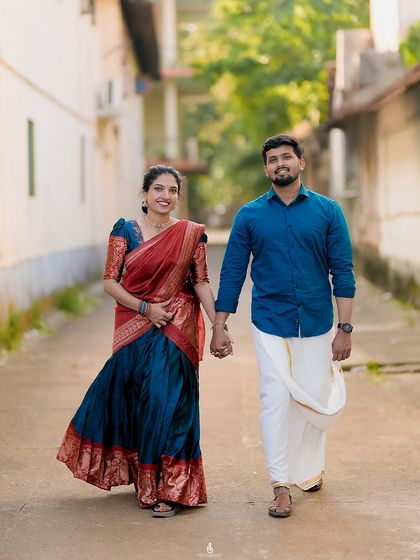 A classic walking shot, hand-in-hand. Their coordinated traditional outfits bring a touch of elegance to the casual street scene.
