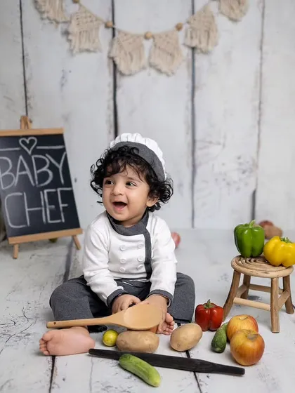 Let's get creative! This little one is styled as a baby chef, complete with a hat, uniform, and fresh veggies. I have a wide range of fun themes like this at my studio.