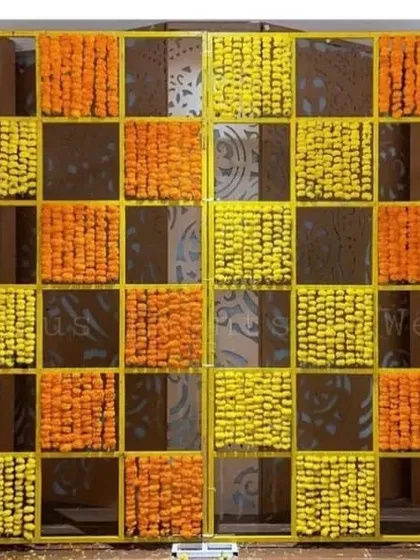 A fun and vibrant photo wall is a must-have for any mehandi ceremony. This popular checkered design uses fresh orange and yellow marigolds, creating a bright and cheerful backdrop that your guests will love for photos.