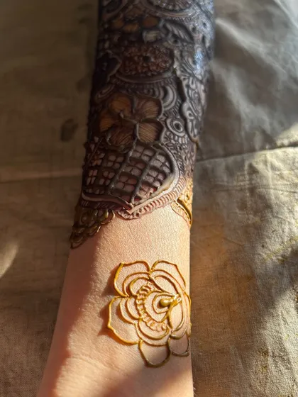 A close-up of the details, with a single rose drawn on the wrist to start the design.
