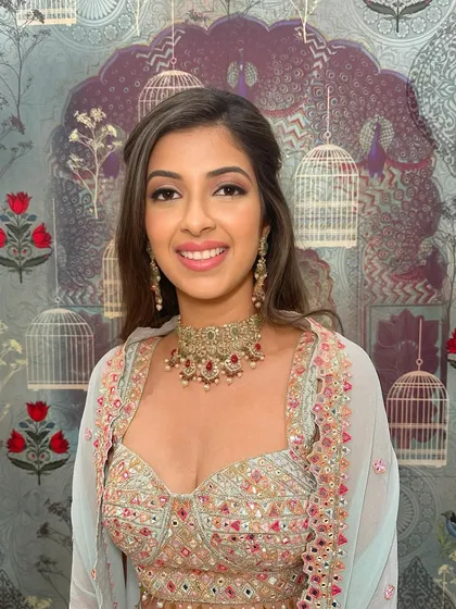 This Mehendi look is soft, romantic, and glowing. I used warm, peachy tones on the eyes and cheeks to complement her pastel outfit, creating a look that is both pretty and sophisticated.