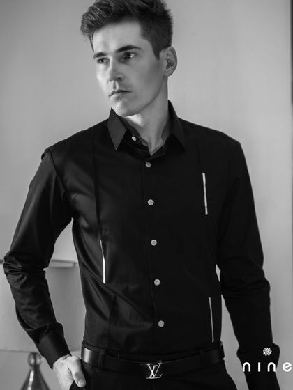 From our 'Metal Bling' collection, this black shirt features clean, vertical metal strips. It's a minimalist design with a modern, architectural feel.