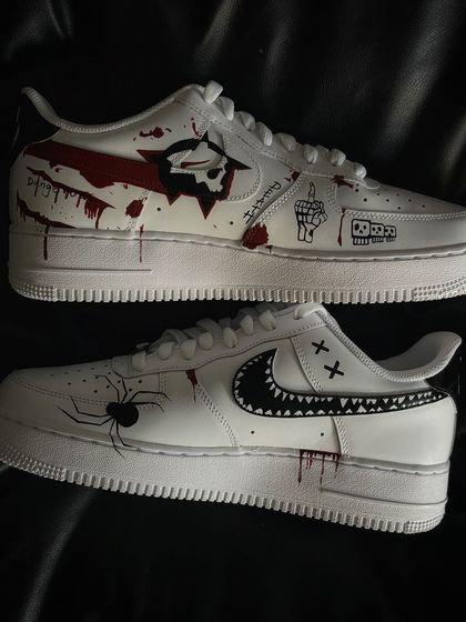 A pair shot showing the different spooky designs on each shoe.