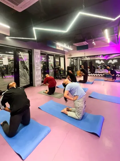 Find your calm and build your strength in our dedicated yoga studio. This is a space for our members to connect with their mind and body through guided practice, like this group performing the Camel Pose (Ustrasana).