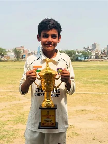 One of our key players with the winning trophy. His smile says it all.