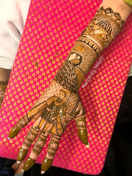 A beautiful bridal mehendi with a groom figure, a peacock, and doli elements. This design tells a story while maintaining a classic and elegant feel.