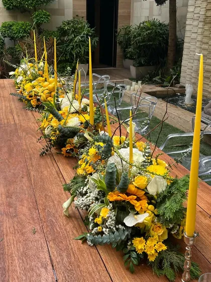 I continued the "lemon and sunflower" theme with this long table runner, accented with matching yellow tapered candles. The playful decor brings a fresh burst of color and a fun twist, perfect for an outdoor celebration.