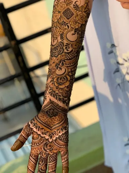 A view of the full arm design, showing the beautiful contrast between the detailed patterns and the clean lines at the wrist.